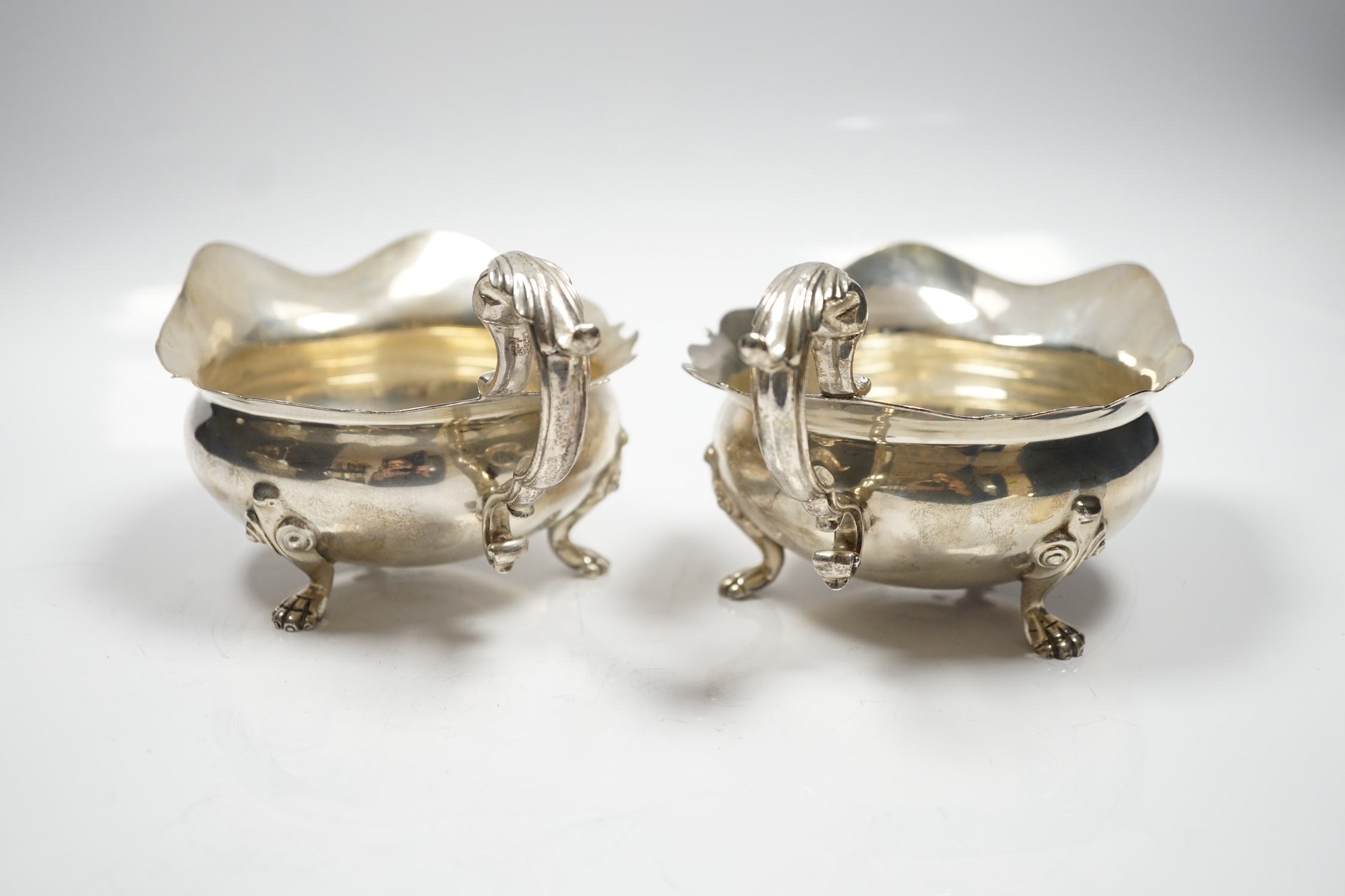 A pair of George V silver sauce boats, by Goldsmiths & Silversmiths Co Ltd, London, 1927 and 1932, length 18.2cm, 15.3oz.